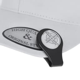 A white cap featuring a black clip-on ball marker with a printed design and a logo.