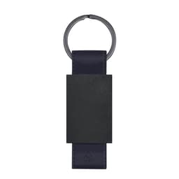 A navy blue keyring with a rectangular black panel and a metal ring attachment. It features a branding logo.