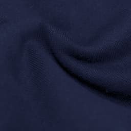 A close-up of soft, navy fabric with a smooth texture, featuring slight folds and creases.