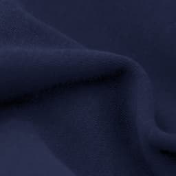 A close-up of dark navy fabric, featuring a soft texture and slight folds. The material appears smooth and inviting.
