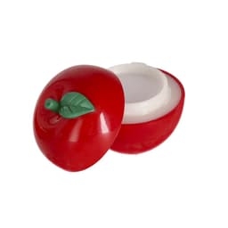 A red apple-shaped lip balm container with a green leaf on top, showcasing a white balm interior.