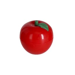 A red lip balm container shaped like an apple, featuring a green leaf on top and a smooth surface.