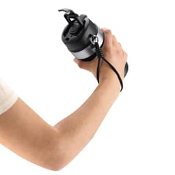 A drink bottle featuring a black design with a silver band, held by a hand with a wrist strap attached.