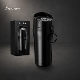 A black insulated cup with a lid and a keyring, alongside a matching box featuring branding.
