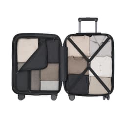 A suitcase with a black exterior, fully packed with neatly folded clothing in various shades of beige and grey.