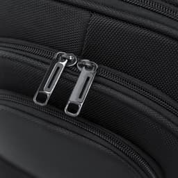 A black backpack featuring dual zippered compartments and a textured fabric surface. It includes a logo.
