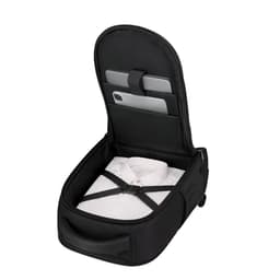 A black backpack with an open zippered compartment, featuring a shirt secured inside and space for devices.