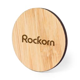 A round bamboo coaster with a natural finish and a logo engraved on the surface.