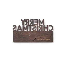 A magnet featuring a wooden design with the text "Merry Christmas" in a bold font and a circular attachment.