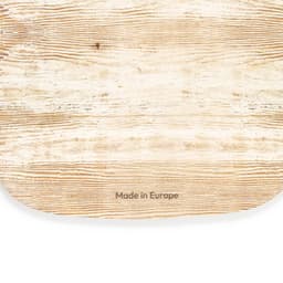 A light-coloured wooden cutting board with a natural grain pattern and rounded edges, featuring a brand logo.