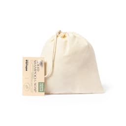 A natural cotton pouch containing solid shampoo and soap, featuring a tag and a logo.