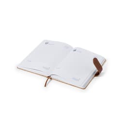 An open diary with blank pages, featuring a brown leather strap and a cork cover. It includes a branding logo.