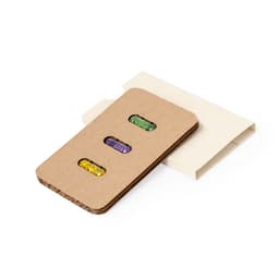 A gift set featuring a card with seeds in green, purple, and yellow, packaged in a white sleeve.