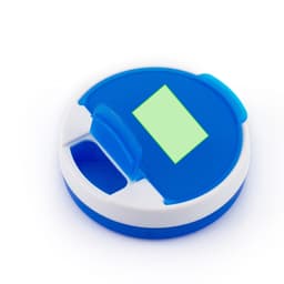 A round blue and white pillbox featuring a green compartment cover and a small opening for easy access.