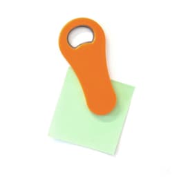 An orange bottle opener sits atop a green sticky note. The bottle opener features a circular opening and a smooth grip.