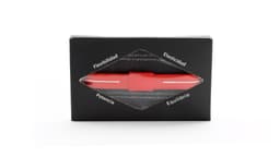 A red energy bracelet displayed in a black box with a clear window, featuring various descriptive terms around the edges.
