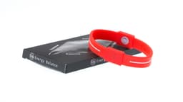 A red silicone wristband beside its packaging, featuring a logo on both the band and the box.