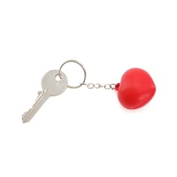 A red heart-shaped stress keyring attached to a metal keychain alongside a silver key.