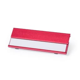 A red metal name badge holder with a sliding mechanism for displaying a badge.