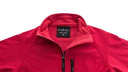 A red soft shell jacket featuring a zippered collar and branded label at the neck.