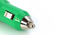 A green USB car charger with a metal tip, featuring a simple design and a logo.