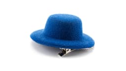 A blue woolen hair clip with a unique hat shape and a metal clasp underneath.