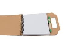 A brown spiral-bound notebook with blank pages and a green pen included. Features a handle on the cover.