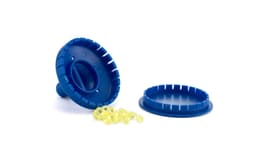 A blue air freshener with a removable lid and yellow fragrance beads scattered nearby. Contains a logo.
