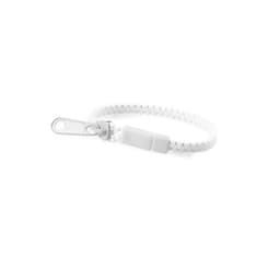 A white Hirion bracelet with a secure fastening, featuring a simple yet stylish design. Includes branding details.