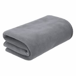 A folded grey blanket made of soft material, featuring a simple design and a stitched edge.