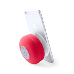 A red Bluetooth speaker with a control panel, leaning against a silver smartphone. It has a branding logo.