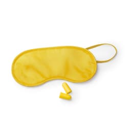 A yellow eye mask with two earplugs beside it, designed for promoting relaxation and sleep.