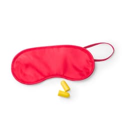 A red sleep mask with yellow earplugs placed beside it, featuring a strap for secure wear.