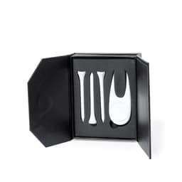 A golf accessory set in a black box, featuring three white tees and a golf marker. The interior is cushioned in black.