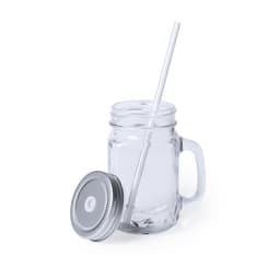 A glass drinking jar with a silver lid and a white straw. The jar is transparent and has a handle.