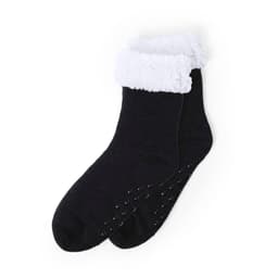 A pair of black socks with a white, fluffy cuff and non-slip dots on the bottom. Branding is present.