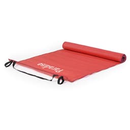 A red outdoor mat with a logo, rolled out flat and featuring two black straps for carrying.