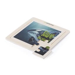 A wooden puzzle featuring an ocean scene with a whale. The puzzle has a logo and is primarily in natural wood tones.