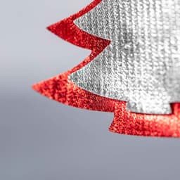 A decorative Christmas tree ornament in red and silver, featuring a textured design. It has a shiny finish.