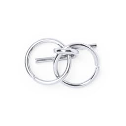 A silver metal ring puzzle with interlocking loops and a central bar. It has a shiny, sleek finish.