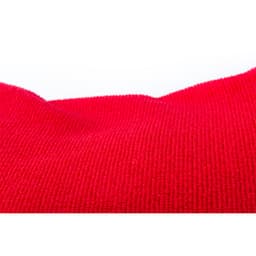 A red textured towel with a soft surface, featuring a logo. Suitable for leisure and outdoor use.