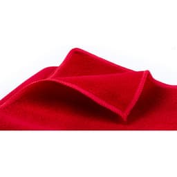 A red towel with a folded edge, made from a soft, absorbent fabric. It features a logo.