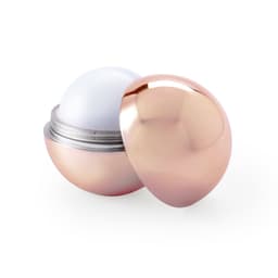A lip balm in a round, metallic rose gold container with a smooth, white balm inside.