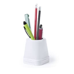 A white pen holder containing various pens and pencils in green, red, black, and blue. It has a simple design.