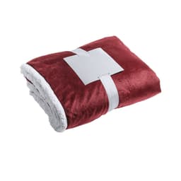 A plush red blanket with a white fluffy lining, neatly folded and secured with a band. It features a logo.