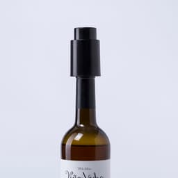 A drink bottle in amber glass with a black cap, featuring a logo on the body.