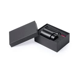 A black wine set in a sleek box, including a bottle and accessories, featuring a polished design and foam insert.