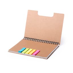 A brown notebook with a spiral binding and colourful sticky tabs in pink, yellow, blue, and green. It has a logo on the cover.