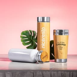 A drink bottle collection featuring a bamboo thermos, a white vacuum flask, and a bamboo coffee cup with stainless steel accents.