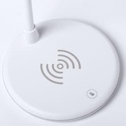 A white multifunction lamp base with a wireless charging area and a small branding logo.